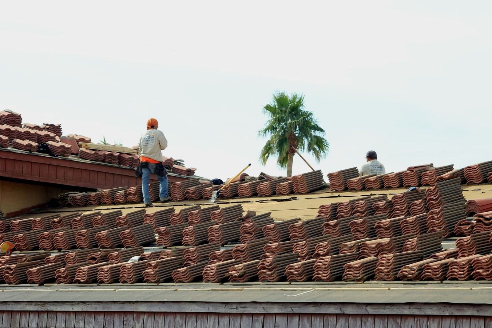Roofer installing wooden roof framework during residential construction